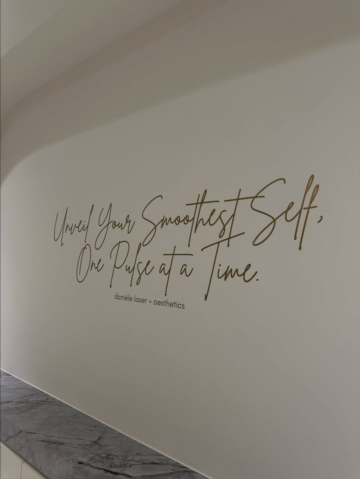 Product and treatment wall inside a Daniéle Laser + Aesthetics studio